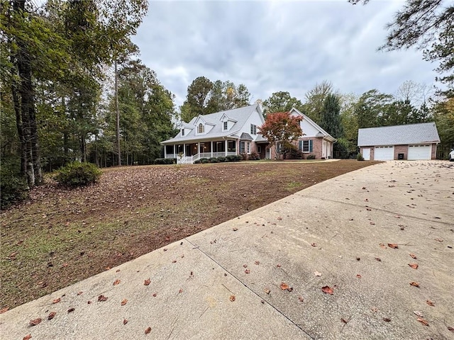 view of front facade with a porch, a garage, and an outdoor structure