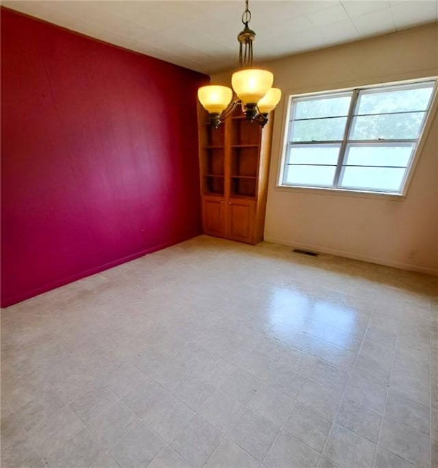 735 Willow St, Alexander City, AL 35010 - unfurnished room featuring an inviting chandelier, baseboards, and visible vents