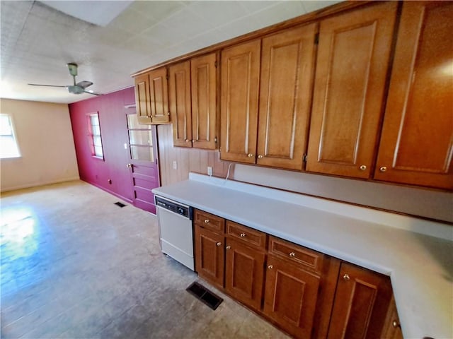 735 Willow St, Alexander City, AL 35010 - kitchen with visible vents, white dishwasher, brown cabinets, light countertops, and tile patterned floors
