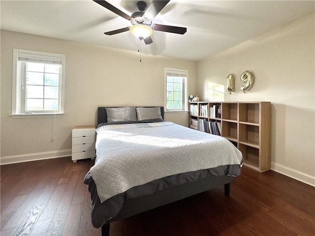 bedroom with baseboards, hardwood / wood-style flooring, and ceiling fan