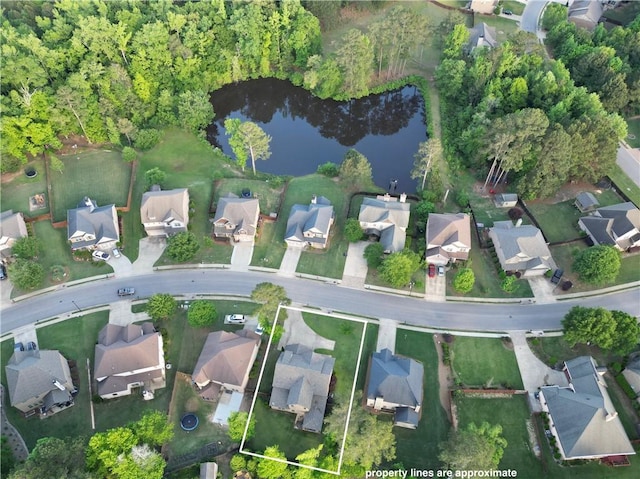 view of property location with property boundaries highlighted, nearby suburban area, and a nearby body of water