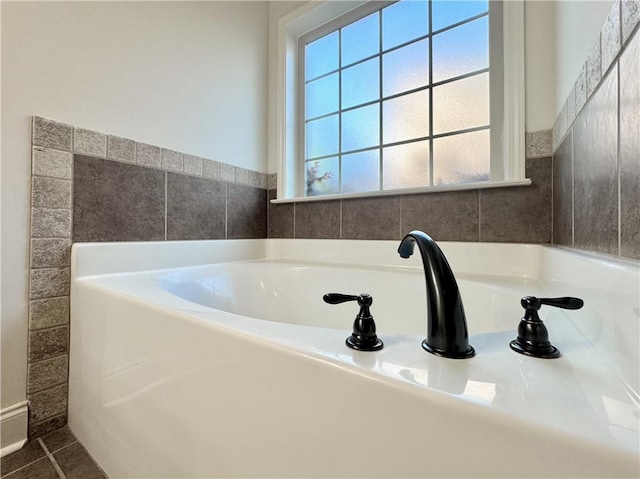 bathroom featuring a garden tub and tile patterned floors