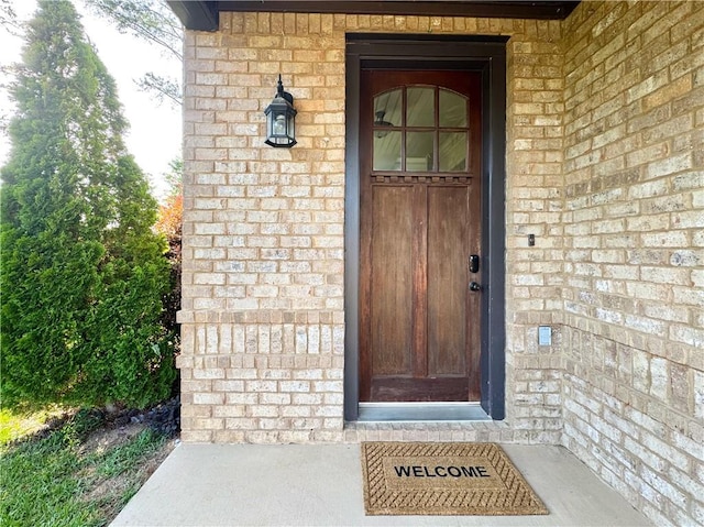 property entrance with brick siding