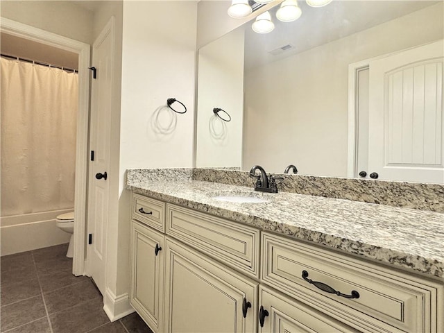 full bathroom with tile patterned floors, vanity, toilet, and shower / bath combo