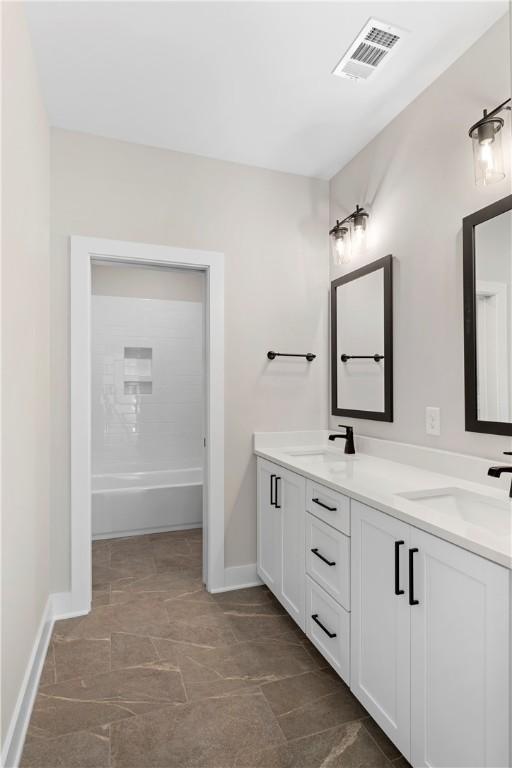 bathroom featuring vanity and shower / bathtub combination