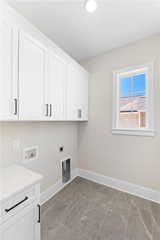 laundry area with cabinets, washer hookup, and hookup for an electric dryer