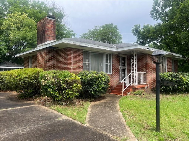 3414 Suwanee Dr, Montgomery, AL 36108 - view of front of property with a chimney, brick siding, and a front yard