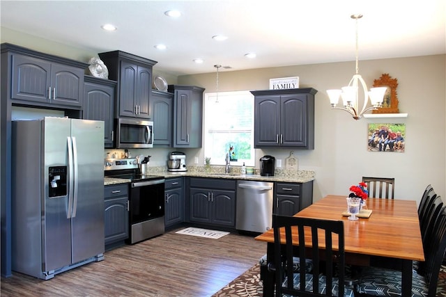 346 Waverly Ln, Jacksons Gap, AL 36861 - kitchen with stainless steel appliances, a chandelier, dark wood finished floors, light stone counters, and recessed lighting
