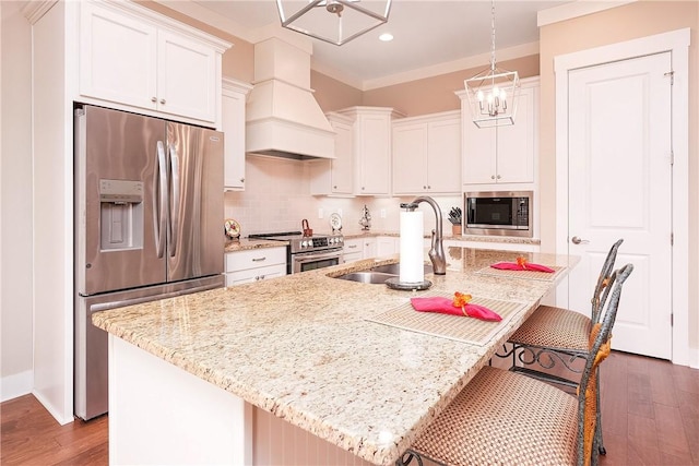 kitchen with premium range hood, a kitchen island with sink, a sink, tasteful backsplash, and stainless steel appliances