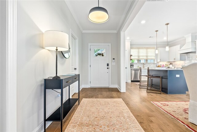 2402 Furlong Trl, Auburn, AL 36830 - entrance foyer featuring light wood-type flooring and crown molding