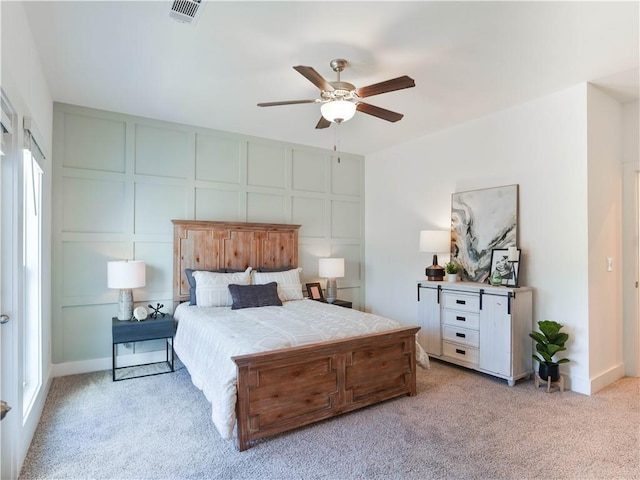 bedroom featuring light colored carpet and ceiling fan