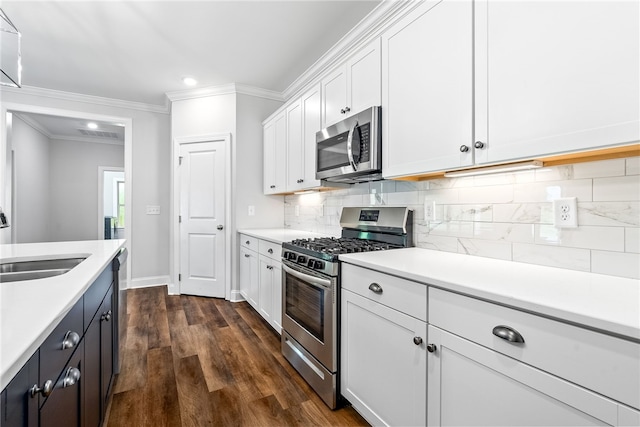 3053 Mimms Trail Rd, Auburn, AL 36832 - kitchen with stainless steel appliances, light countertops, white cabinetry, ornamental molding, and backsplash