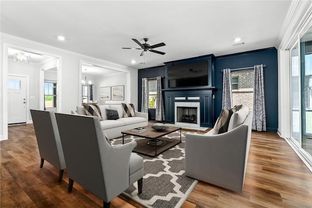 3053 Mimms Trail Rd, Auburn, AL 36832 - living room with crown molding, a chandelier, wood finished floors, a fireplace, and a ceiling fan