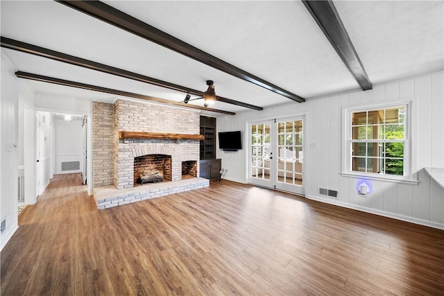 2 Lakewood Cir, Phenix City, AL 36867 - unfurnished living room featuring wood finished floors, a fireplace, beam ceiling, and french doors