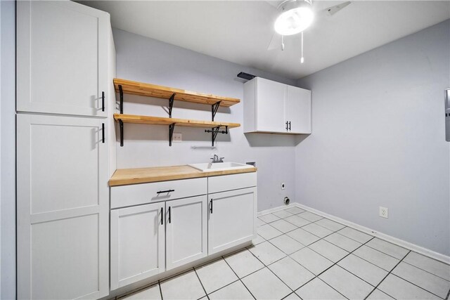 2 Lakewood Cir, Phenix City, AL 36867 - laundry room with cabinet space, electric dryer hookup, a ceiling fan, light tile patterned flooring, and washer hookup