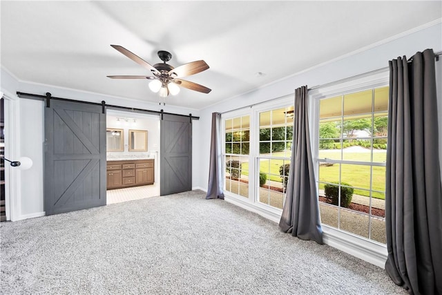 2 Lakewood Cir, Phenix City, AL 36867 - unfurnished bedroom featuring a barn door, carpet floors, crown molding, ensuite bath, and a ceiling fan