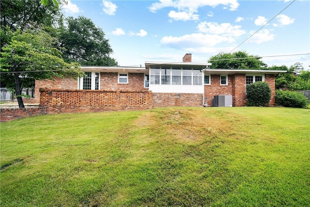 2 Lakewood Cir, Phenix City, AL 36867 - back of house with a sunroom, brick siding, a lawn, and a chimney
