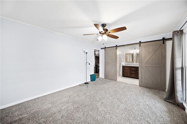2 Lakewood Cir, Phenix City, AL 36867 - unfurnished bedroom with a barn door, light carpet, ornamental molding, ensuite bath, and a ceiling fan