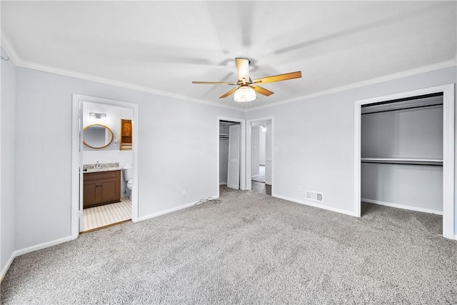 2 Lakewood Cir, Phenix City, AL 36867 - unfurnished bedroom featuring carpet flooring, crown molding, multiple closets, ensuite bathroom, and a ceiling fan