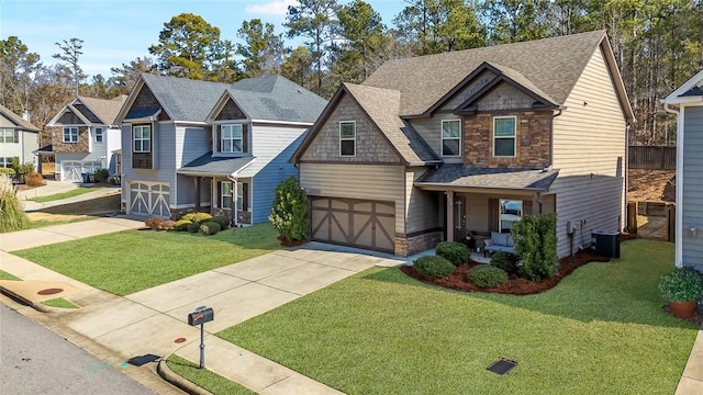 view of front of home with a front lawn, a garage, and central air condition unit