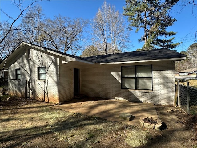 498-500 E University Dr, Auburn, AL 36830 - view of side of home featuring a patio area, fence, and brick siding