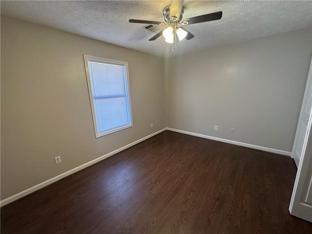 498-500 E University Dr, Auburn, AL 36830 - spare room with a textured ceiling, visible vents, baseboards, a ceiling fan, and dark wood-style floors
