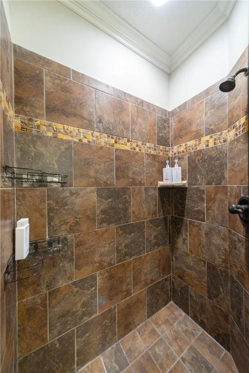 bathroom featuring a tile shower and ornamental molding