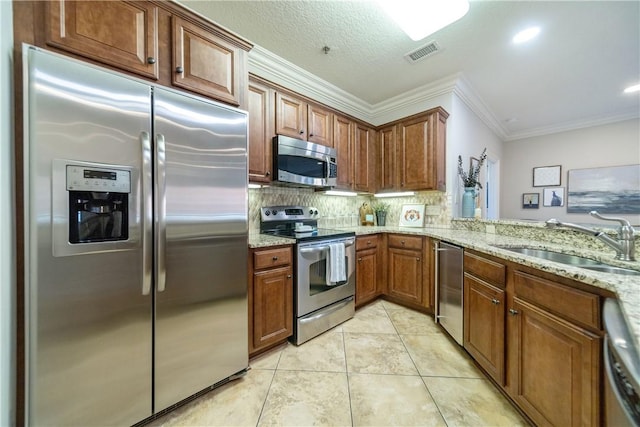 kitchen with light stone countertops, sink, stainless steel appliances, light tile patterned flooring, and ornamental molding