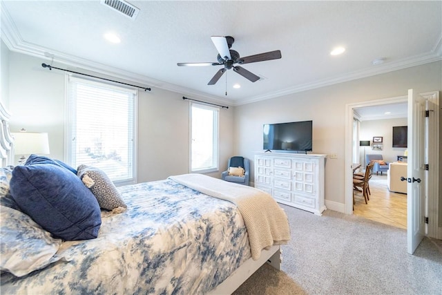 carpeted bedroom with ceiling fan and crown molding