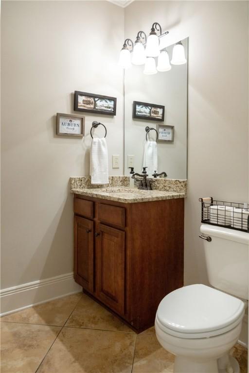 bathroom with tile patterned floors, vanity, and toilet