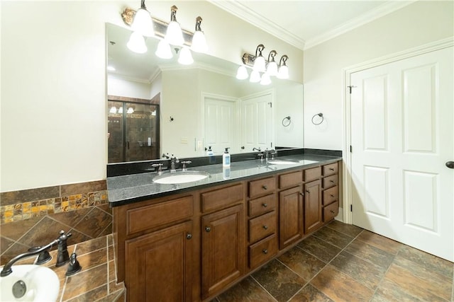 bathroom with vanity, a shower with shower door, and crown molding