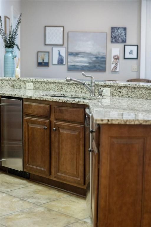 interior space with light stone counters and sink