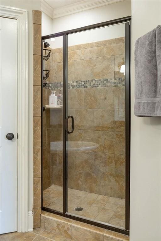 bathroom featuring crown molding and a shower with door