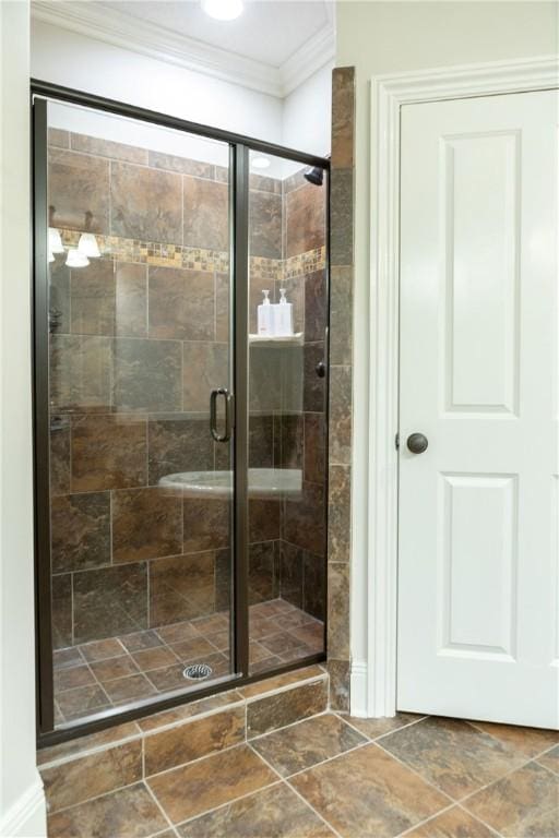 bathroom with a shower with door and ornamental molding