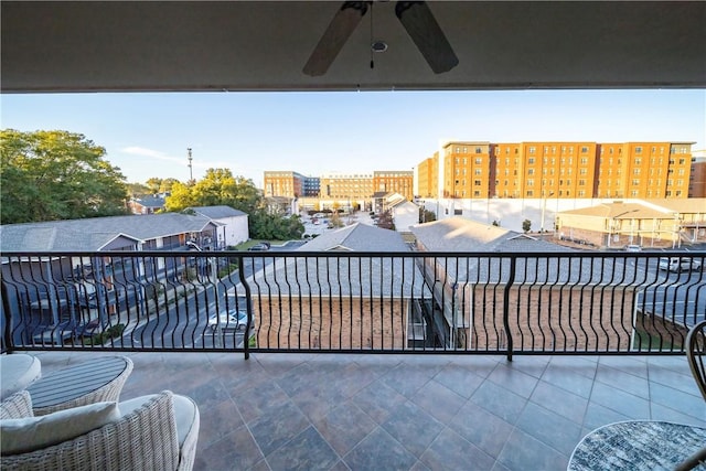 view of patio with ceiling fan and a balcony