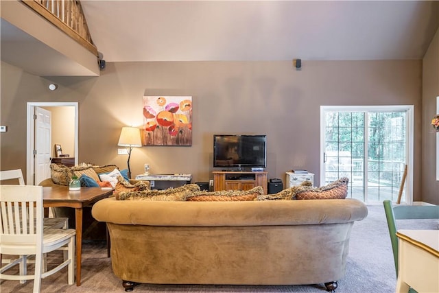 living room featuring carpet floors and vaulted ceiling