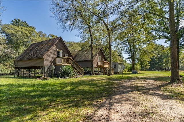 view of property exterior featuring a wooden deck and a yard