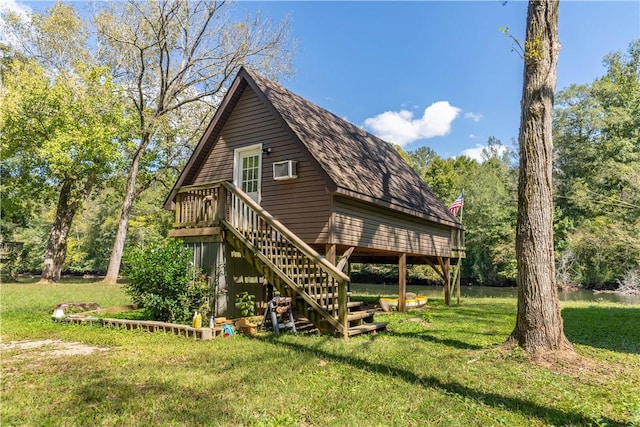 back of property with a deck and a yard