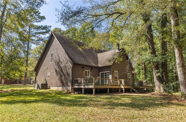 back of property featuring a lawn, cooling unit, and a wooden deck