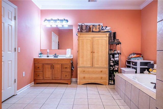 bathroom with tile patterned flooring, vanity, ornamental molding, and tiled tub