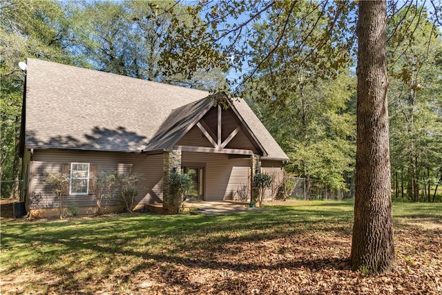 view of front of house featuring a front yard, a patio, and cooling unit