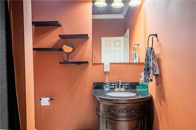 bathroom with a textured ceiling, vanity, and crown molding