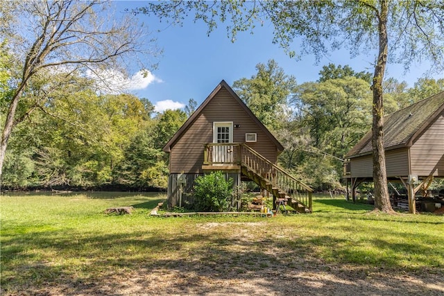 rear view of property featuring a yard