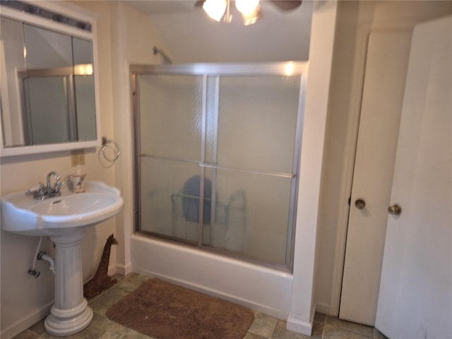 bathroom featuring shower / bath combination with glass door and vaulted ceiling