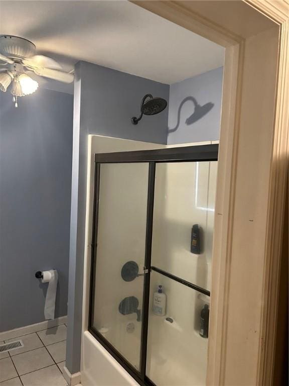 bathroom with ceiling fan, tile patterned flooring, and enclosed tub / shower combo