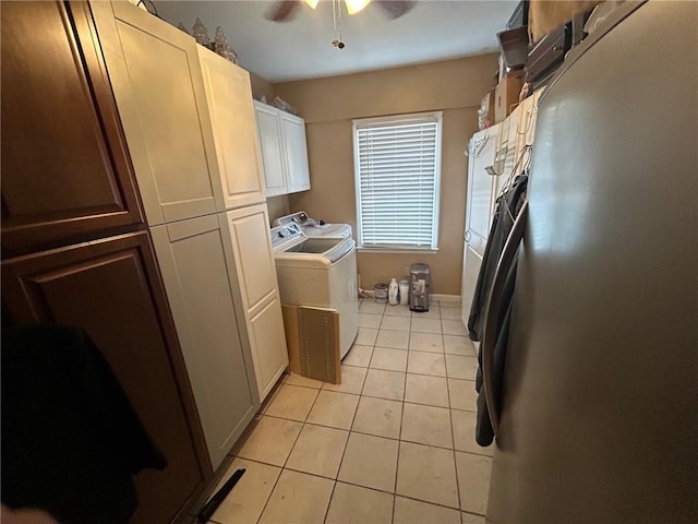 clothes washing area featuring ceiling fan, washer and clothes dryer, light tile patterned floors, and cabinets