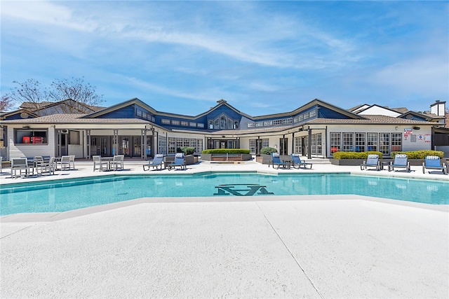 community pool with a patio area