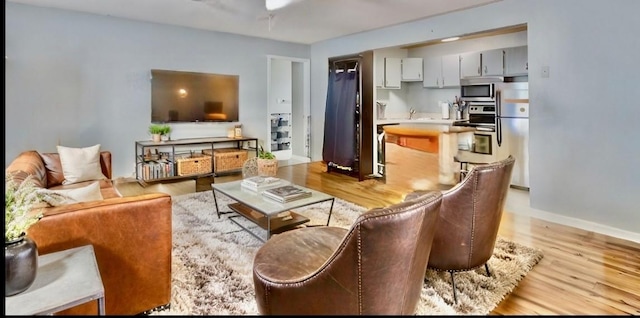 living room featuring baseboards and wood finished floors