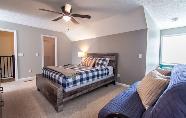 303 N Ross Ave Unit 215, Auburn, AL 36830 - carpeted bedroom featuring a textured ceiling, ceiling fan, and vaulted ceiling