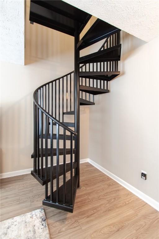 303 N Ross Ave Unit 215, Auburn, AL 36830 - stairway featuring baseboards and wood finished floors